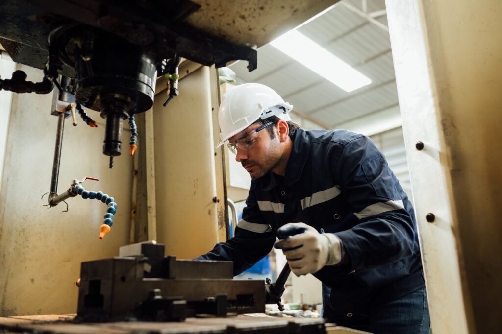 Engineer technician controlling robotic arms on computer laptop